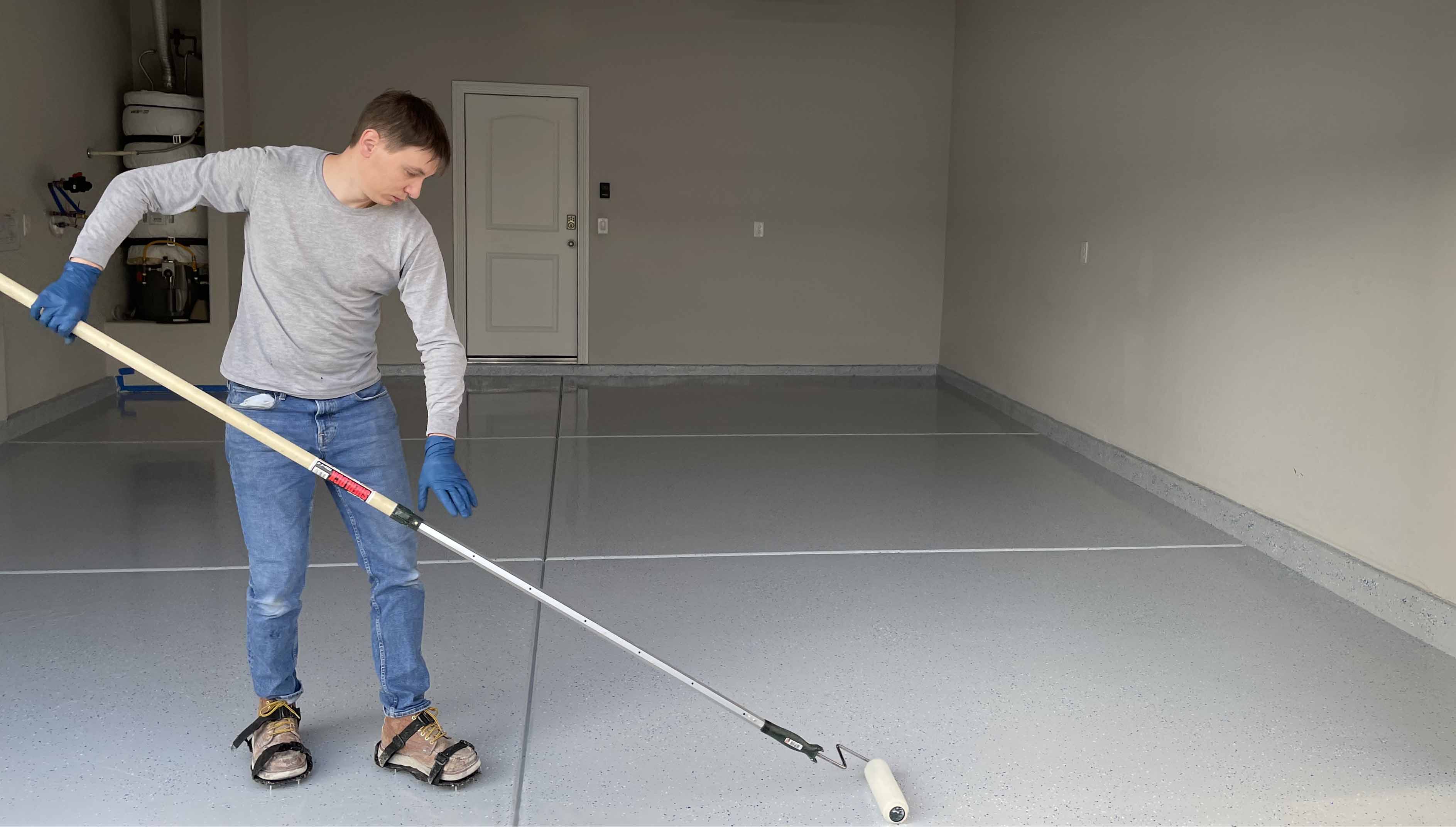 A crew member applies epoxy coating